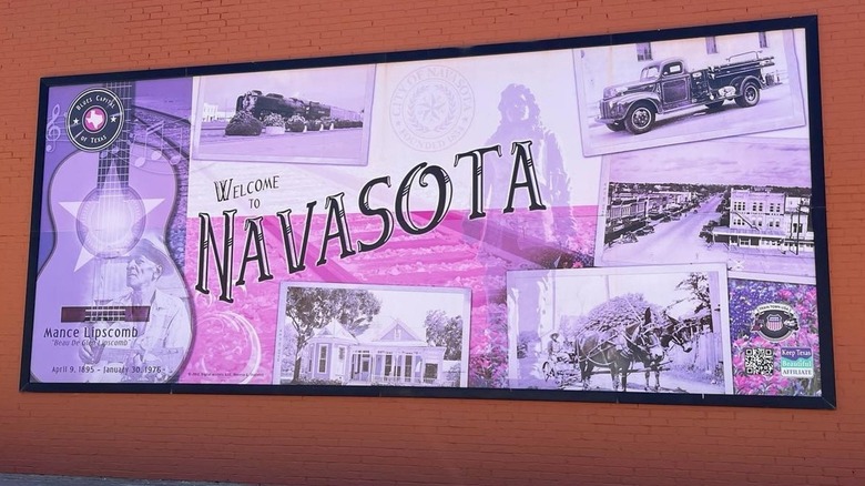 Welcome to Navasota sign on a red brick wall