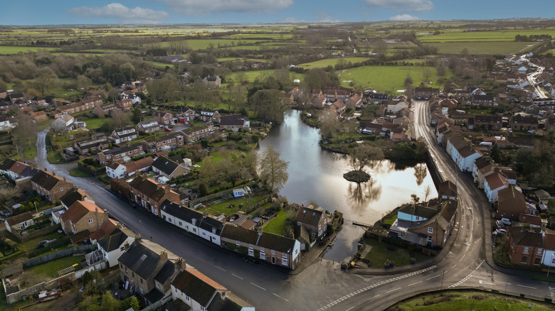 Nafferton's village center with its mere, houses, and surrounding green fields in the Yorkshire Wolds