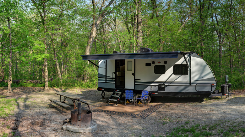RV camping in a rugged setting with benches and firepit