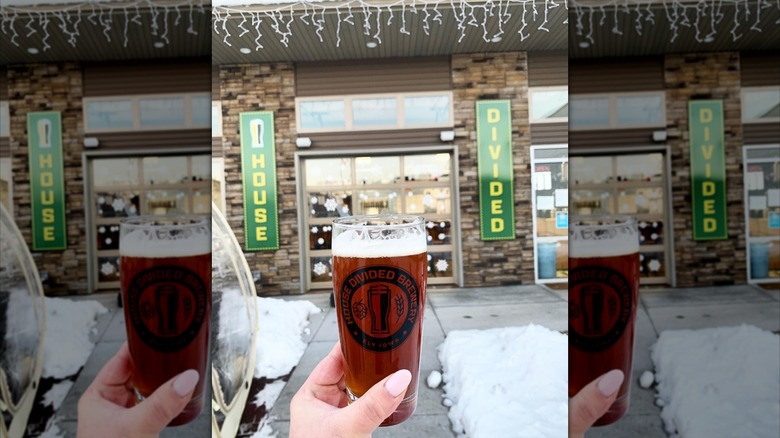 A cup of beer in front of House Divided Brewery