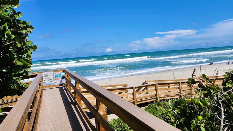 A boardwalk with a ramp leading to the beach at Millennium Beach Park in Brevard County, Florida