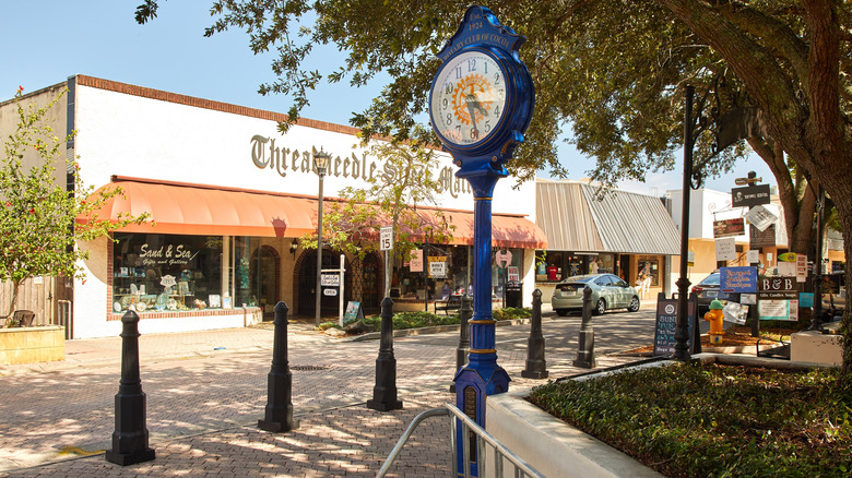 The village square in Cocoa, Florida, featuring brick streets, storefronts, and a blue vintage clock