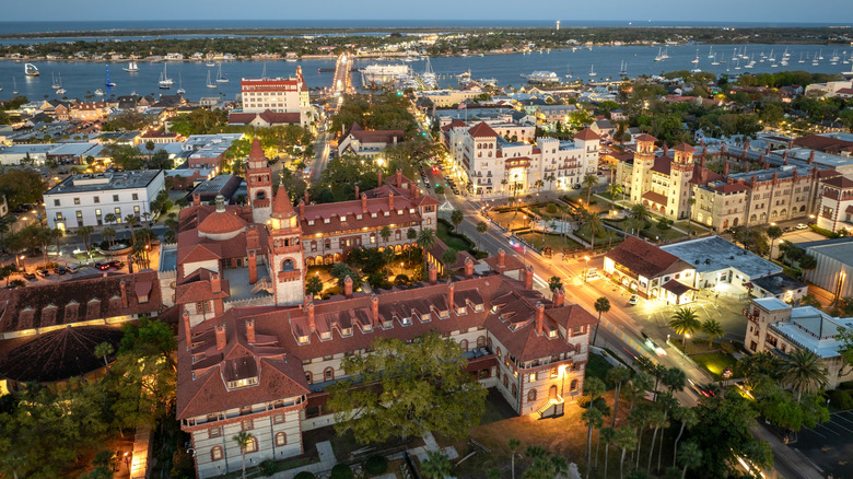 Aerial view of St. Augustine at dusk, white and red buildings, water and boats