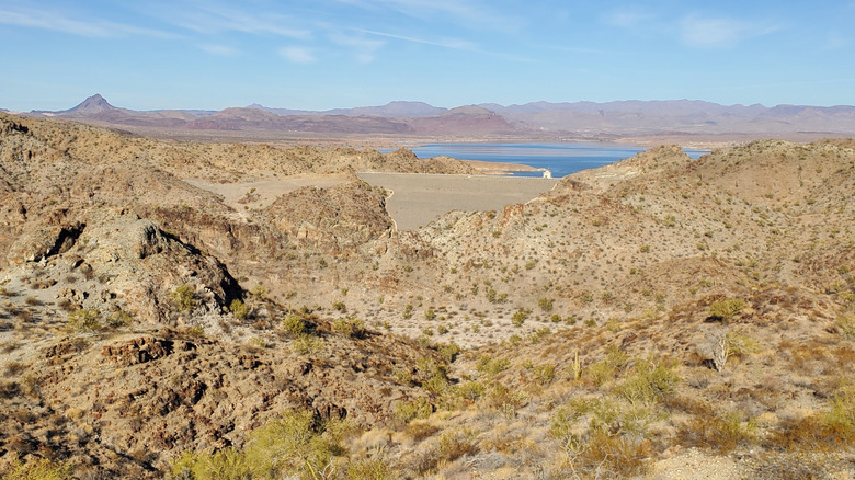 Dusty desert mountains rise around the shores of Lake Alamo