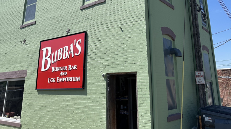 The green brick facade and red sign of Bubba's Burger Bar in Moberly, Missouri.