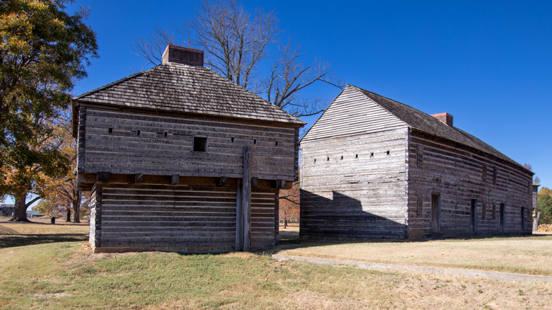 Old buildings in Fort Dobbs on a sunny day under a bright blue sky