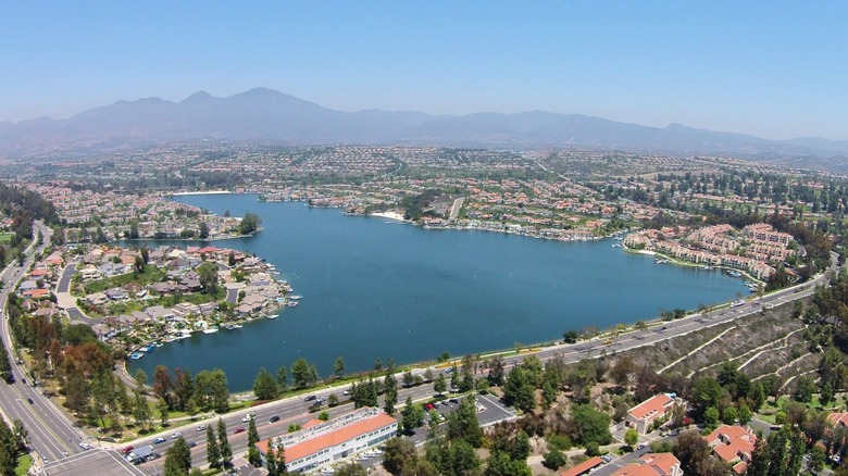 Aerial view of Mission Viejo, California, built around Lake Mission Viejo with mountains in the background