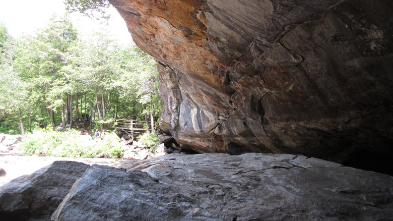 View from inside a cave in Pottersville, New York in the Adirondack Mountains during the day with a small wooden walkway in the background