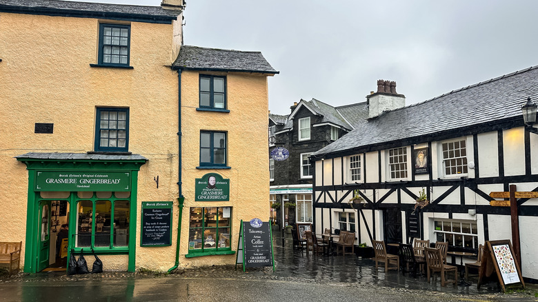 An old gingerbread shop and a Tudor pub on a rainy day in Hawkshead village, Cumbria