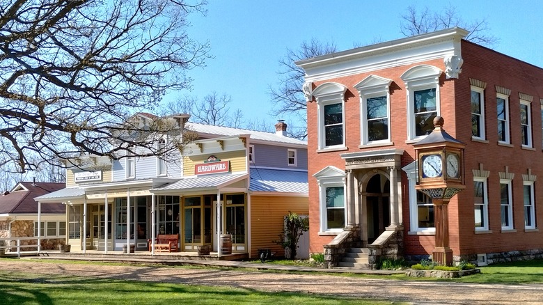 The mock downtown of an 1800s village in Historic Charlton Park, featuring a two-story brick building and a line of one-story wood buildings