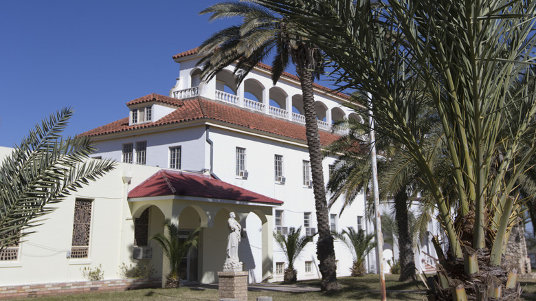 Scotus College in Hebbronville fronted by palm trees.