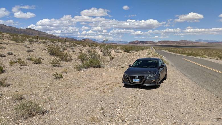 A gray sedan on the side of the road in the Nopah Range Wilderness