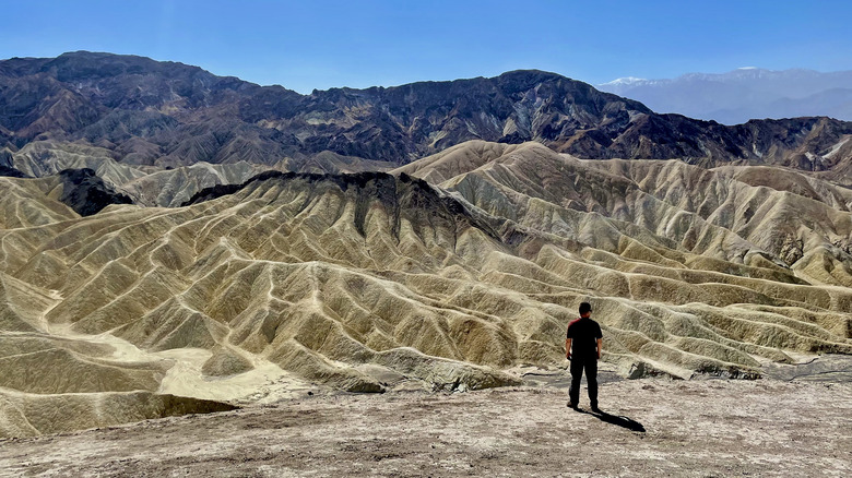 Lone hiker staring at Death Valley