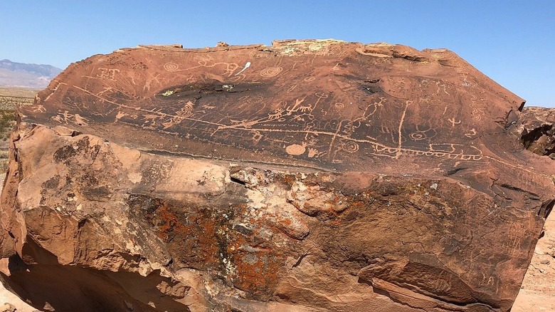 Petroglyphs cover red rock near Utah Arizona border