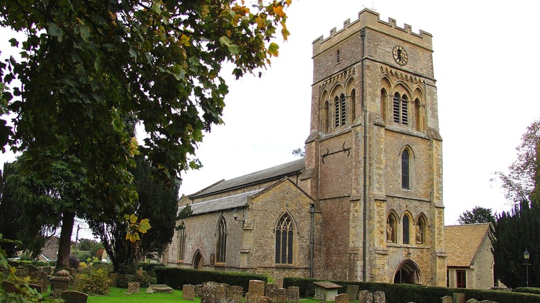 The facade of St. Peter's church in Brackley, England, on a cloudy day