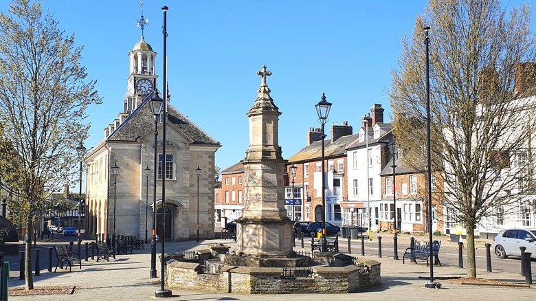 The town center of of Brackley, England, with a war memorial in the foreground and the town hall in the background