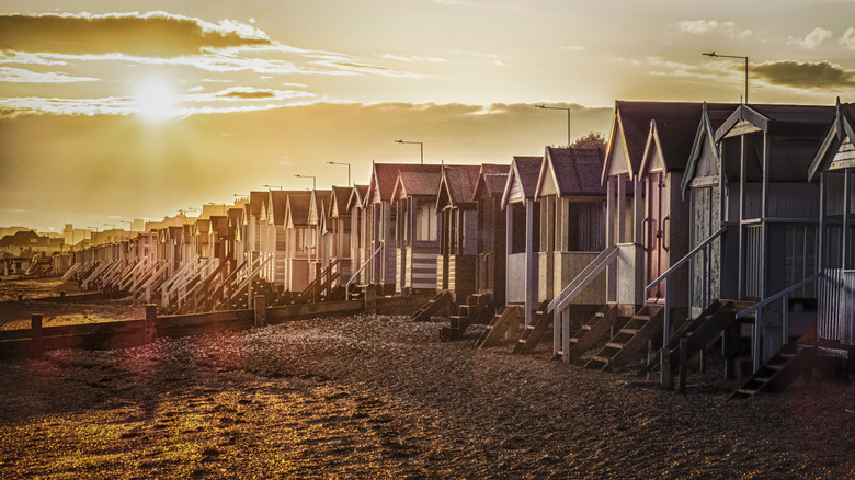 Beach huts on the beach at Southend under a golden sun