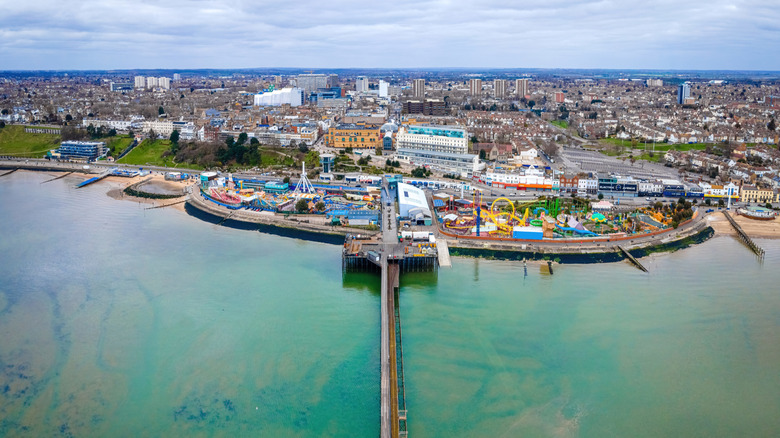 Ariel view of Southend Pier and Adventure Island with buildings and homes behind it, under a blue-grey sky