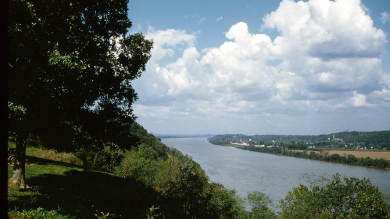View of Ohio River from Hawesville, Kentucky during the day with buildings in the distant background.
