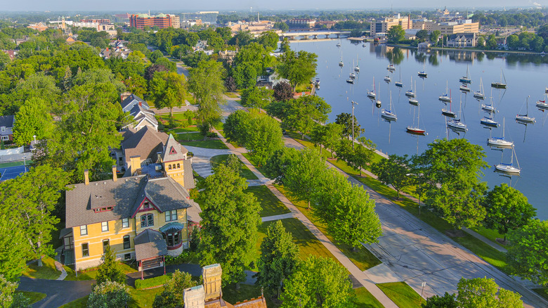Birds-eye view of a neighborhood in Menasha, Wisconsin, with sailboats on a river.