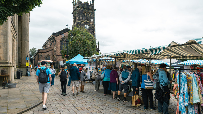 Market stalls in a square outside a church in Macclesfield, Cheshire