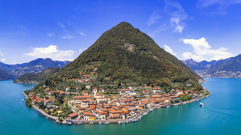 Quaint village nestled on a lush, mountainous island, surrounded by the waters of Lake Iseo near Brescia