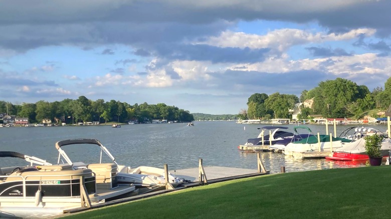Boats tied to shore of Okauchee Lake on a partly cloudy afternoon in Wisconsin