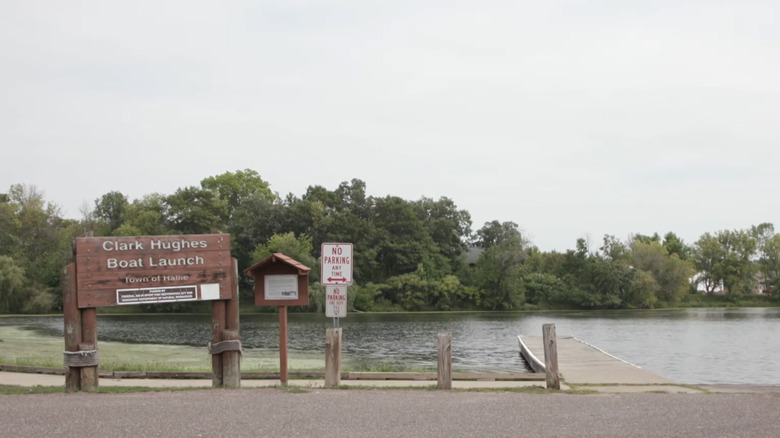 Clark Hughes Boat Launch with sign and boat dock with view of Lake Hallie