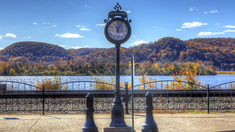 Old clock along riverbank