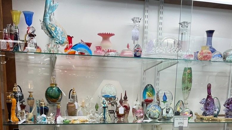 An assortment of antique glass items in case at Antique Warehouse in Salida