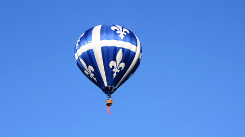 A hot air balloon hovers over Saint-Jean-sur-Richelieu on a sunny day
