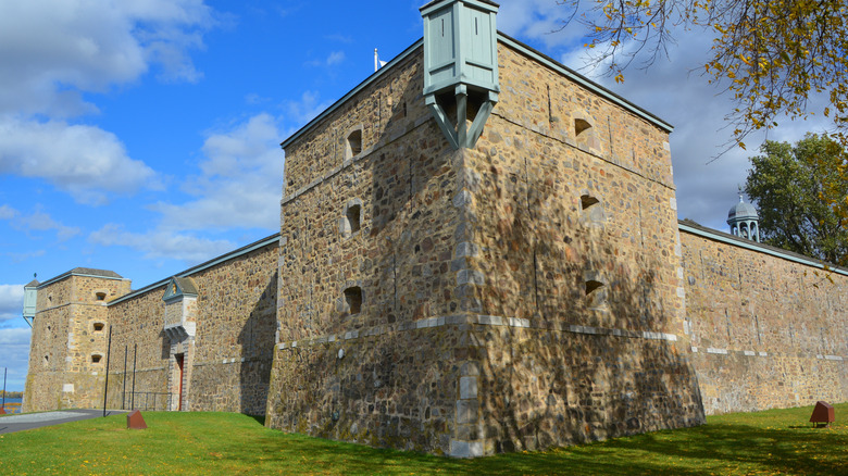 The stone walls of Fort Saint-Jean rise over a grassy lawn
