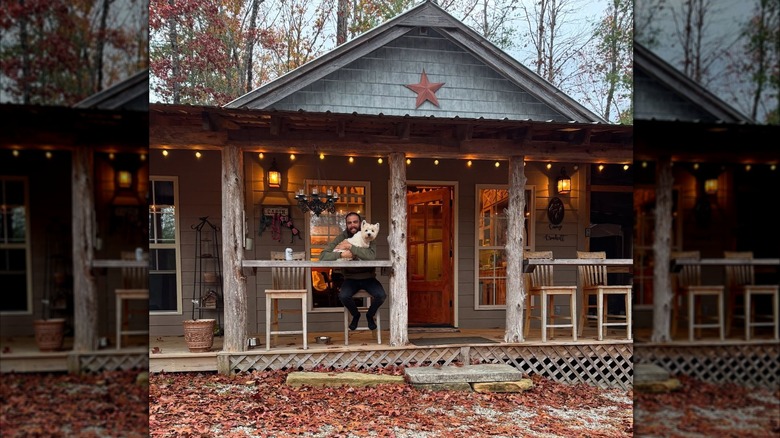A man and his dog at a cabin in Big South Fork National River and Recreation Area, Oneida, Tennessee