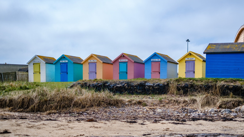 A line of colorful shacks on Little Shore Beach in Amble, England