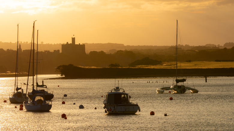 Sunset over boats in the harbor in Amble, England