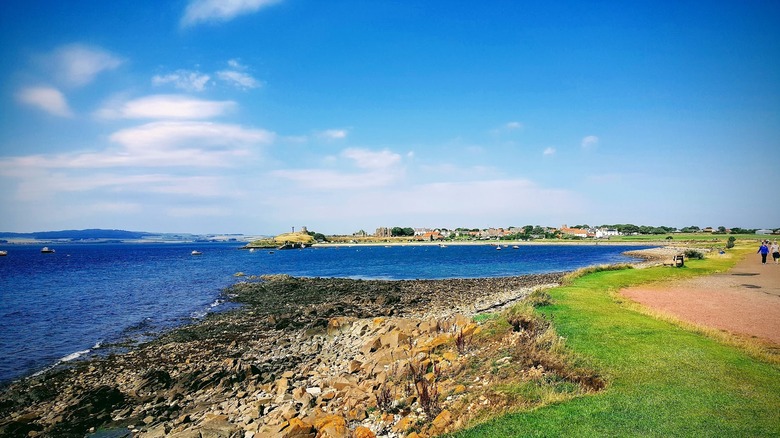 Rocky coastal flats parallel to green path along the coast