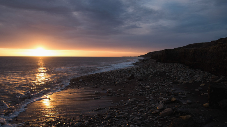 The rocky Horden Beach during sunrise in England.