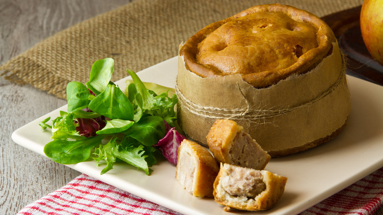 Melton Mowbray pork pie wrapped in brown paper and twine.