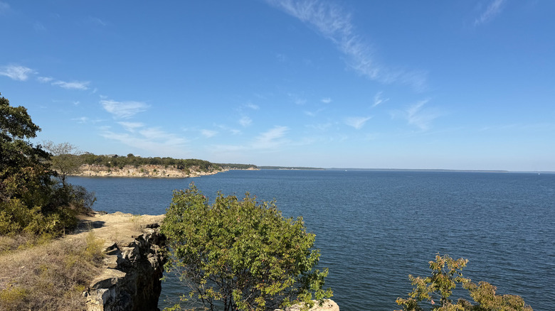 The shoreline lined with rocks and trees at Lake Texoma on the Texas-Oklahoma border