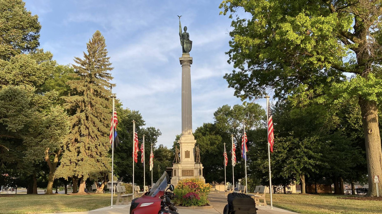 View of monument in City Park surrounded by trees in center of Atlantic, Iowa