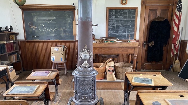 The old stove and desks inside the historic schoolroom at the Wessels Living History Farm in York, Nebraska