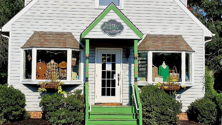 The green front steps and portico entry of Silver and Sassy with clothes and accessories in the bay windows.