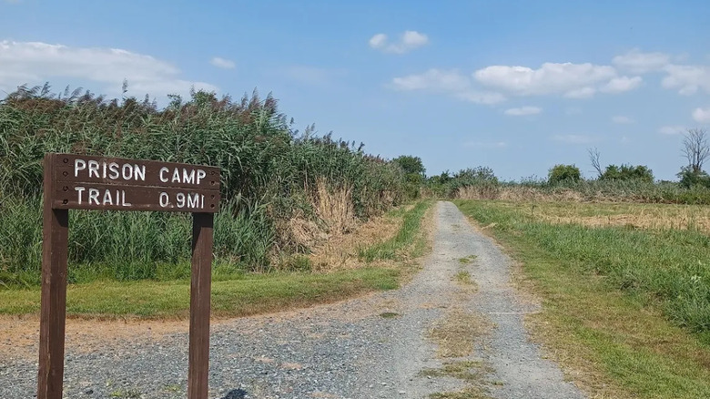 Wooden sign for Prison Camp Trail and pathway
