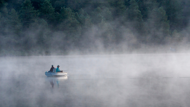 Fishing from a boat at Hawley Lake, Arizona on a foggy day
