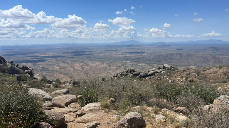 A breathtaking view of blue sky, arid landscape, and distant mountains in Granite Mountain Hotshots Memorial State Park, Arizona