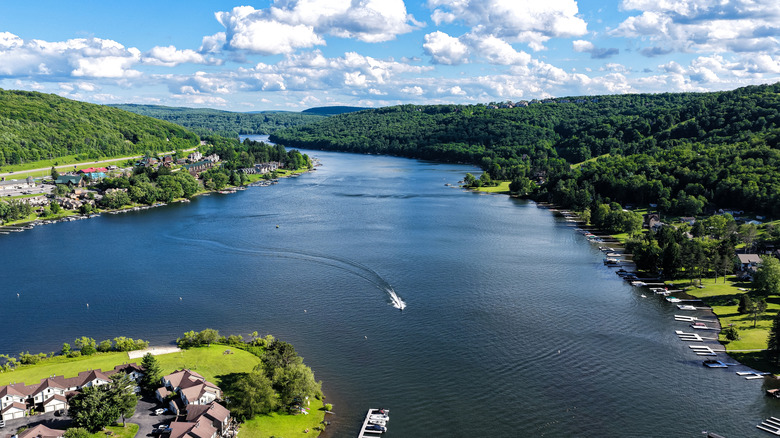 Aerial views of Deep Creek Lake in Maryland, surrounded by lush rolling hills and houses with docks along the shores.