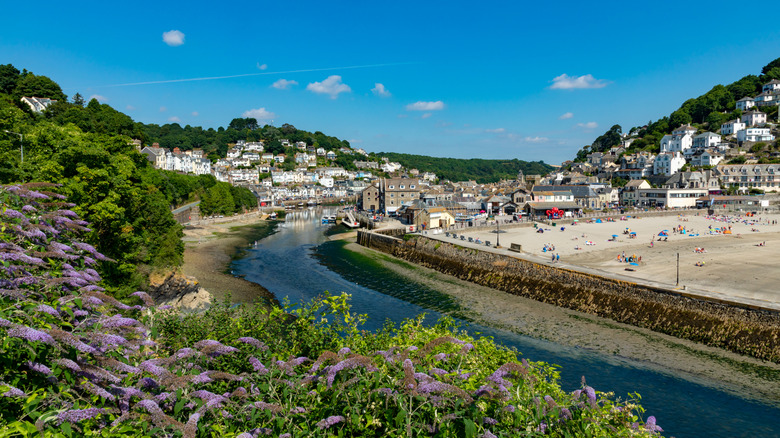 The town of Looe cascades down a hill to a river and beach