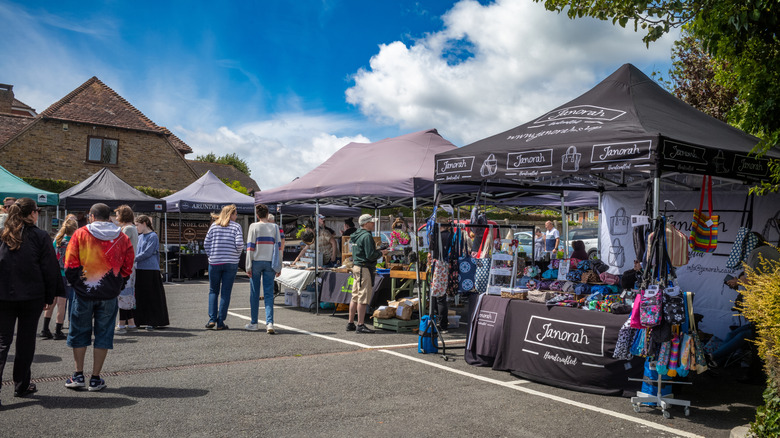 People browsing food and craft stalls on a sunny day at Billingshurst Artisan Market