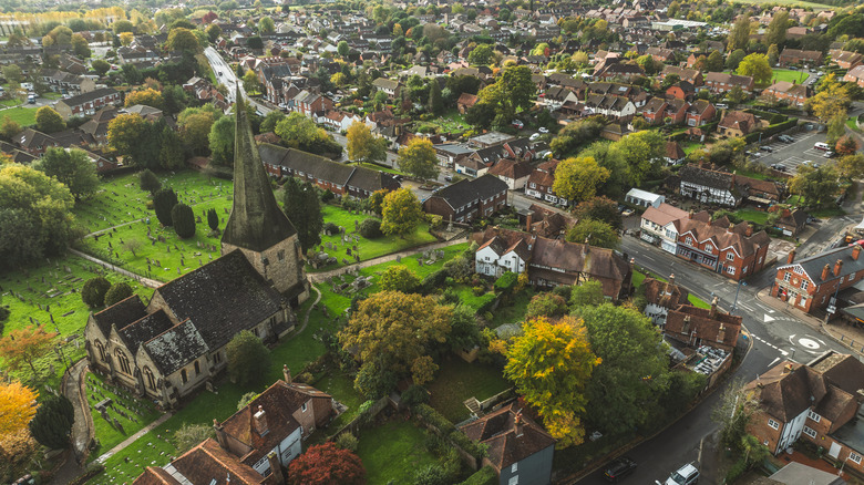 Aerial view of Billingshurst, an historic town in England with St Mary's Church, a graveyard, and classic English buildings along its high street
