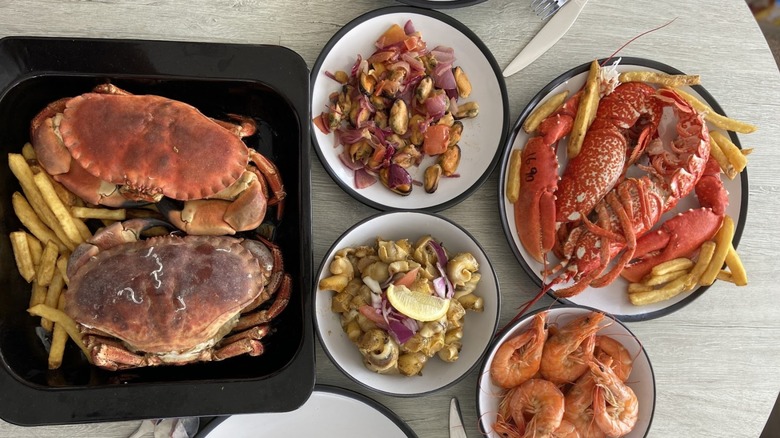 Crabs and other seafood on a table at Julie's at East Beach, Selsey